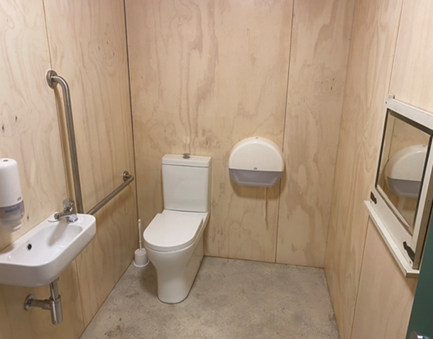 A bathroom with a toilet and sink

Description automatically generated with medium confidence