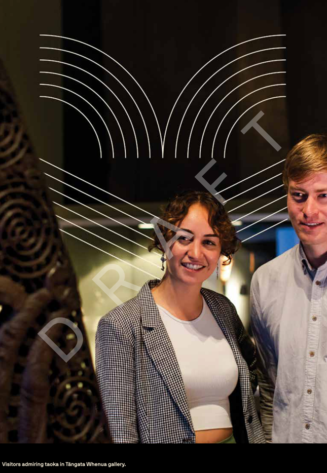 A person and person standing next to a sculpture

Description automatically generated