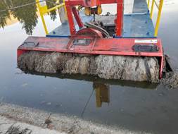 A machine with a brush in the water

Description automatically generated