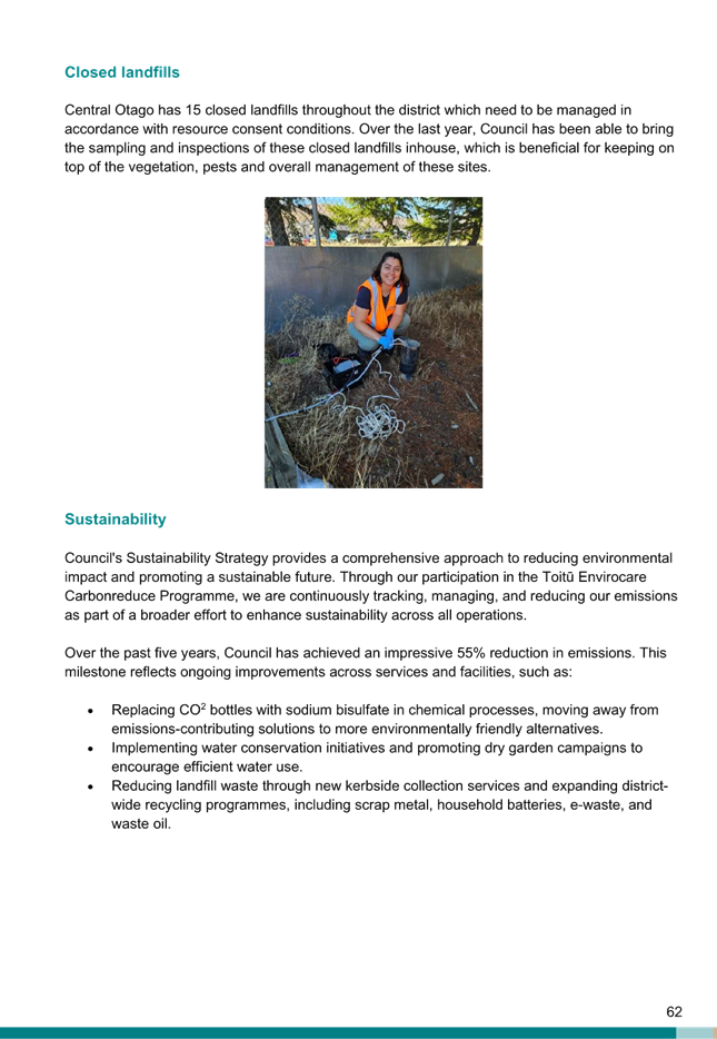 A person in an orange vest sitting on a rock

Description automatically generated