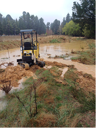 A person driving a bulldozer in a muddy area

Description automatically generated