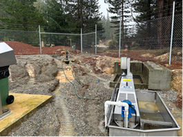 A metal container next to a fence

Description automatically generated