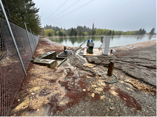 A water next to a fence

Description automatically generated